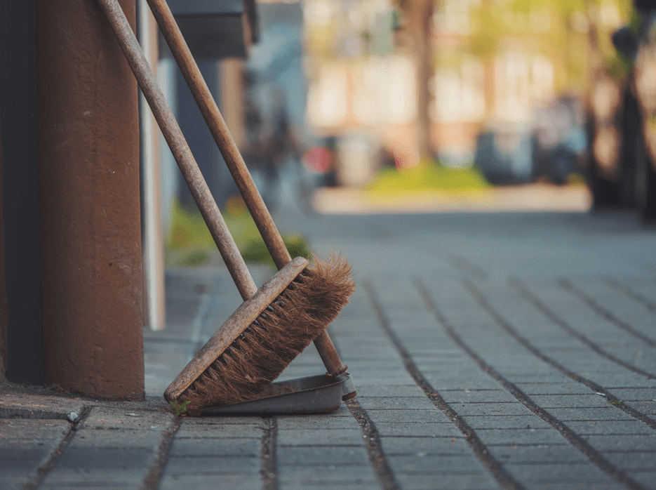 Broom leaning against a wall