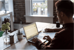 Man on laptop on desk