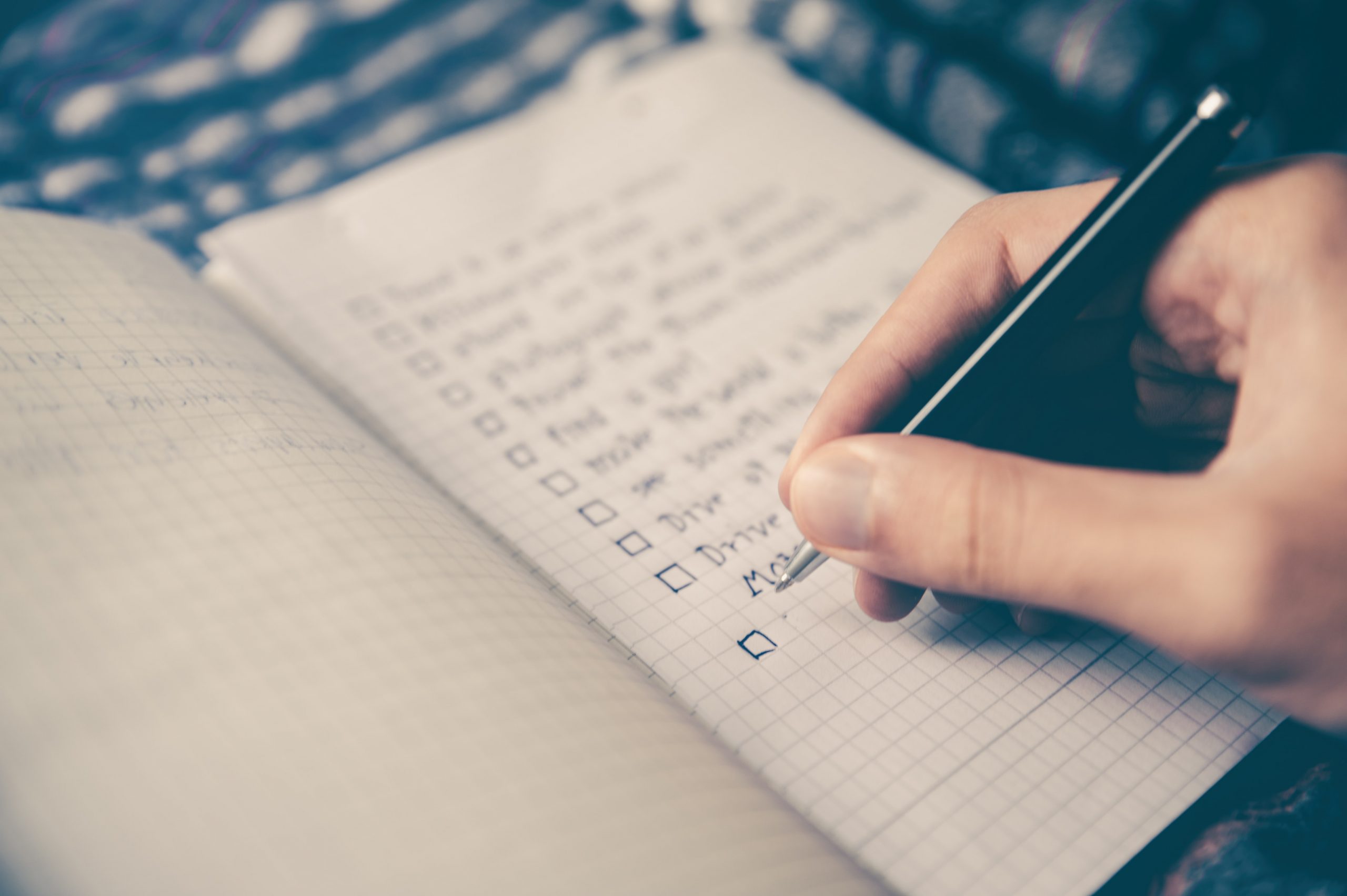 Close up of someone holding a pen and notebook